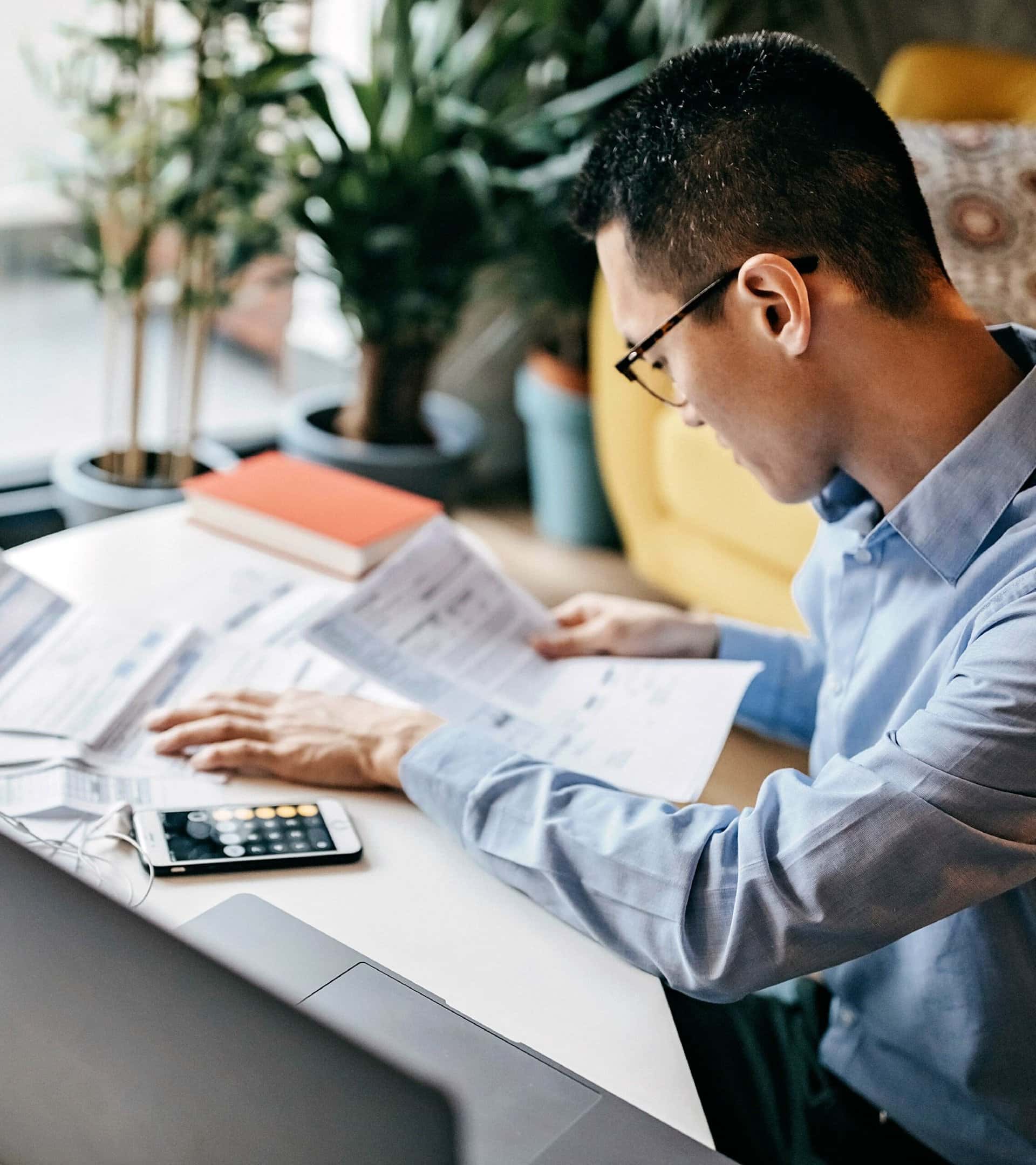 Man calculating costs using a calculator