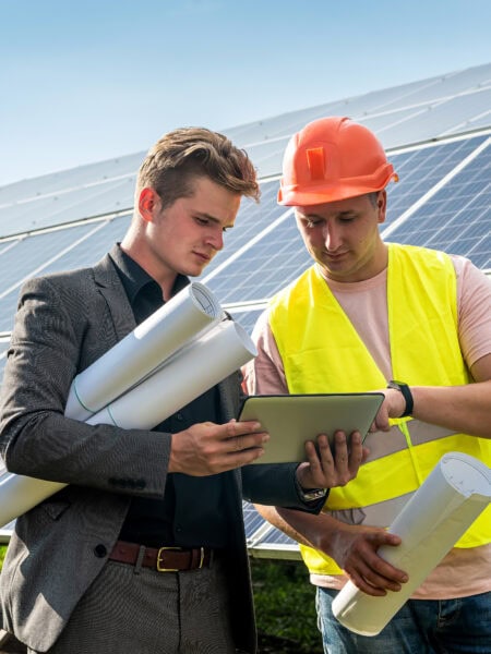 The worker tells his boss how the installation of solar panels